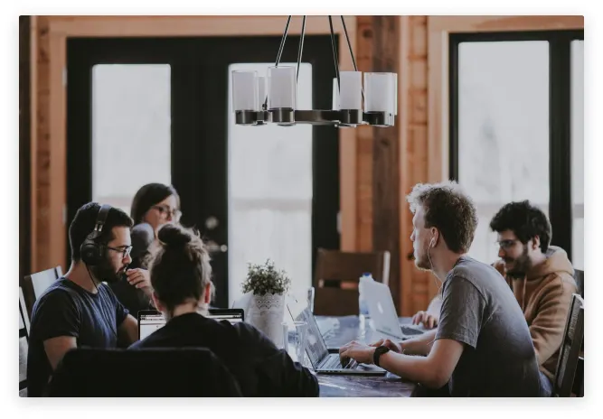 The team working together around a table.